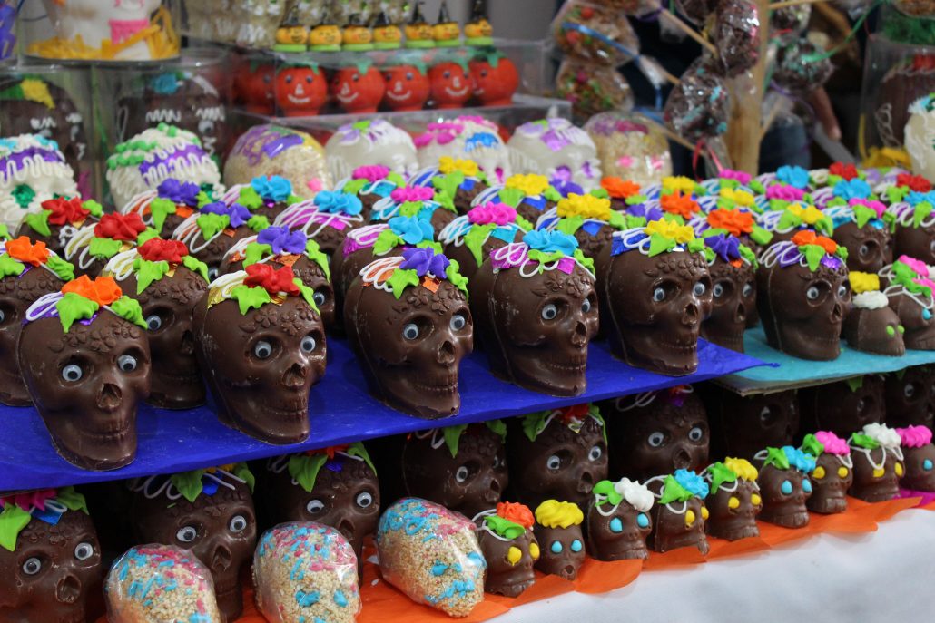 rows of little chocolate skulls and sugar skulls on display